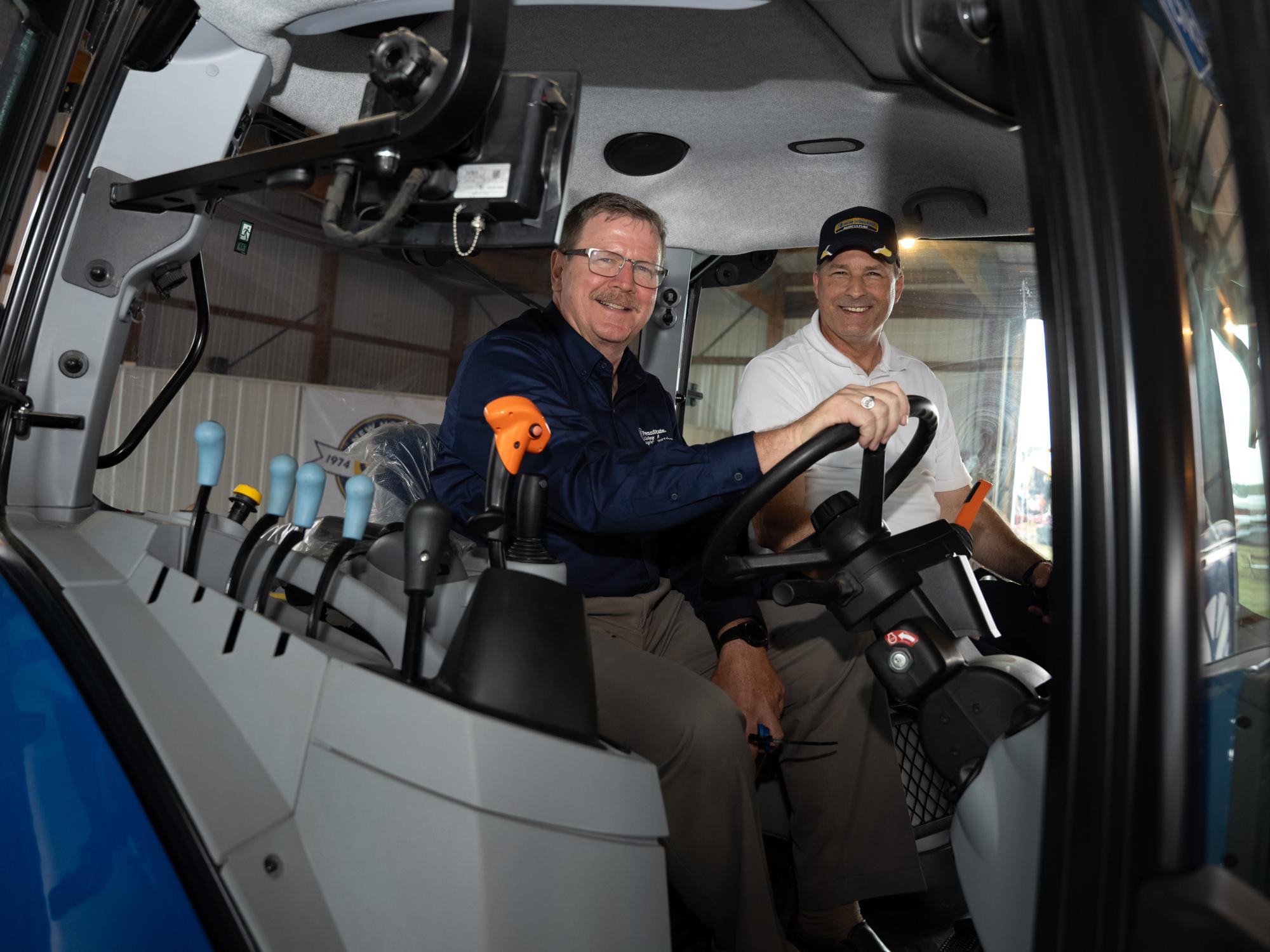 Two individuals sitting in a methane tractor