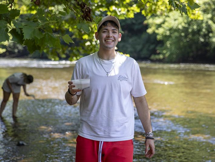 Student smiling with his water sample