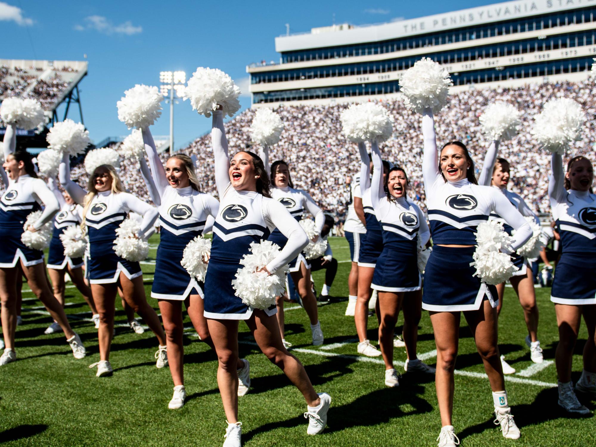 Cheerleading team cheers on the field.