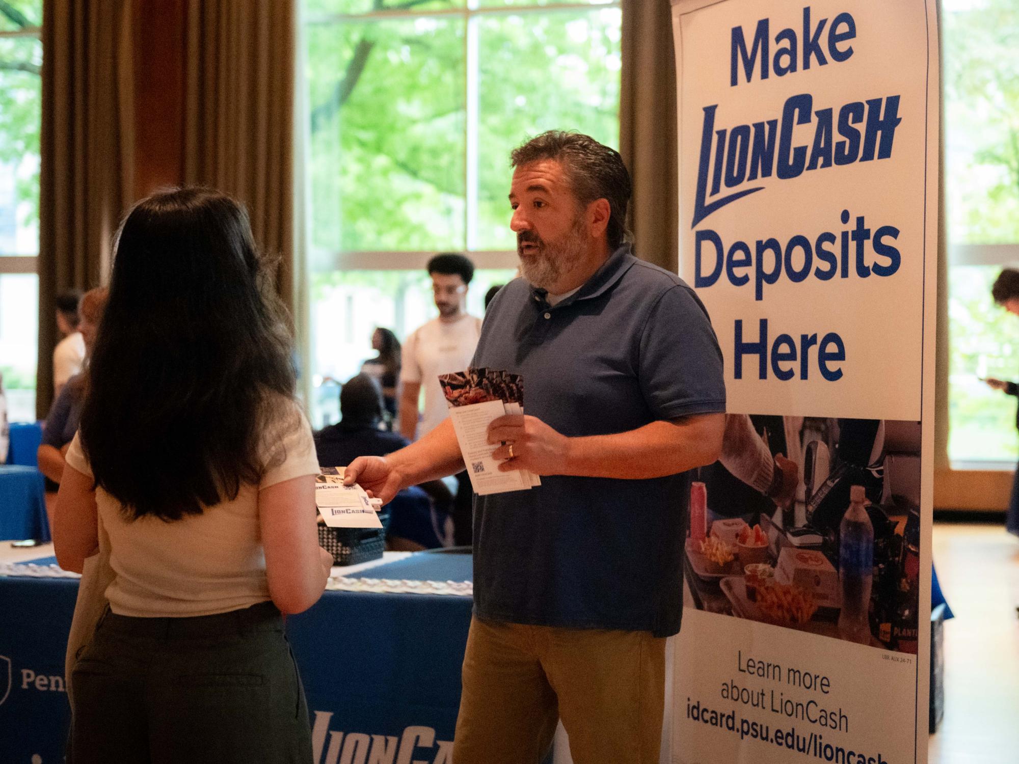 A Penn State staff member talks with a student