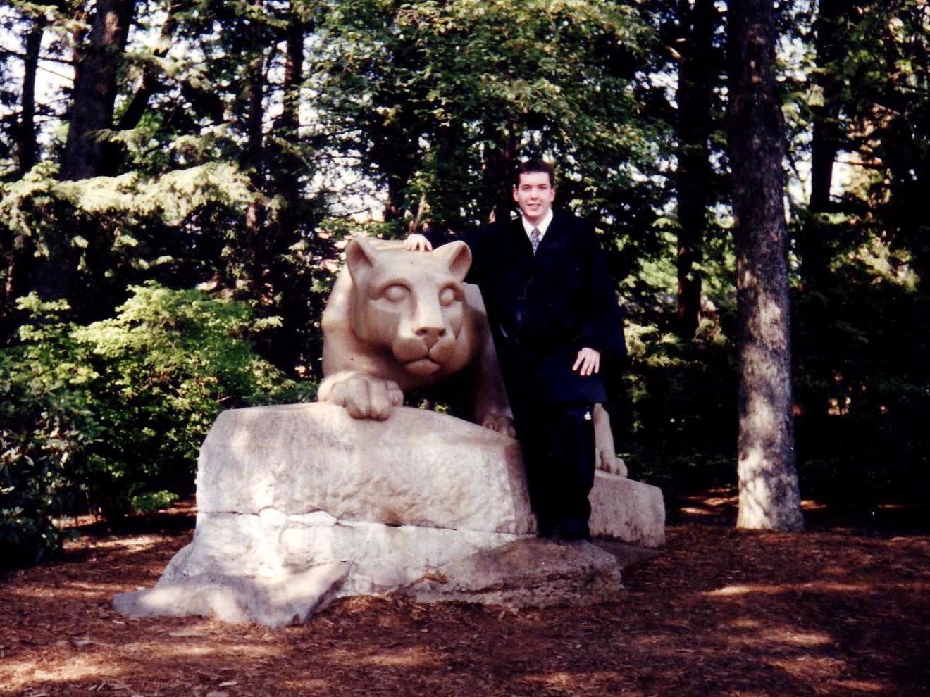 A student poses with the Nittany Lion shrine