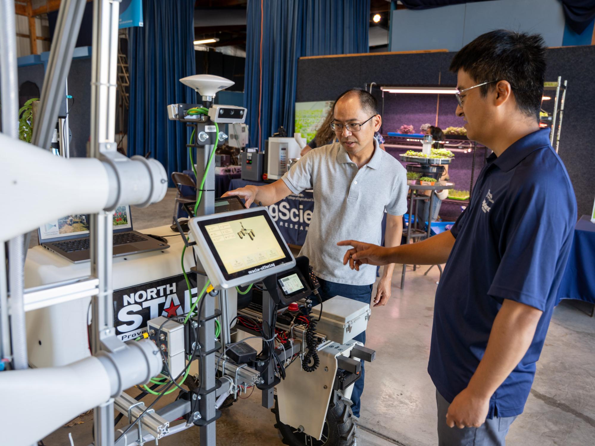 Two individuals interact with a robotics demonstration