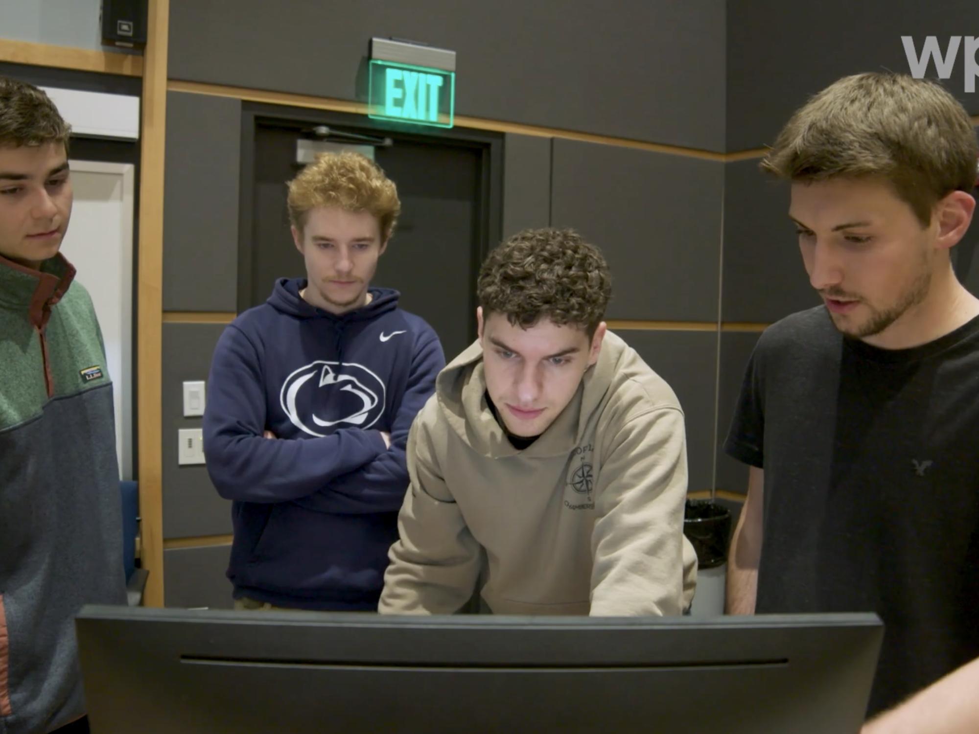 Students in front of a computer screen.