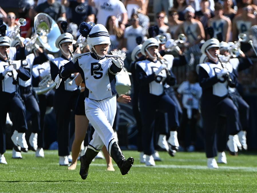 Drum major runs on field