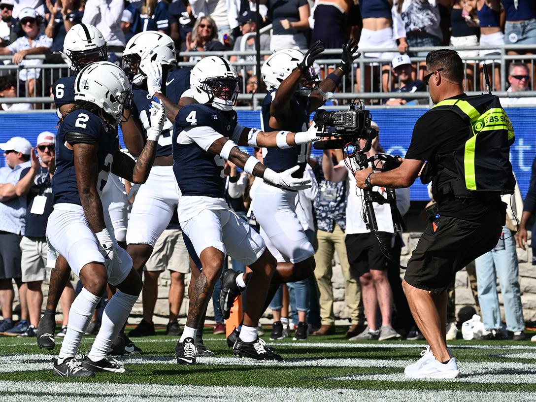 Players celebrate in front of TV cameraman