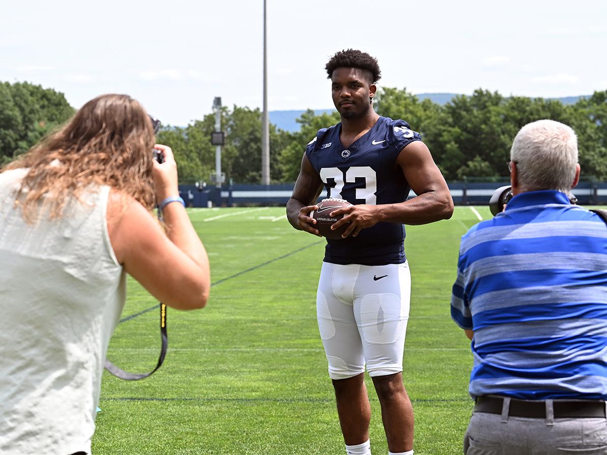 Player poses with ball for photographers
