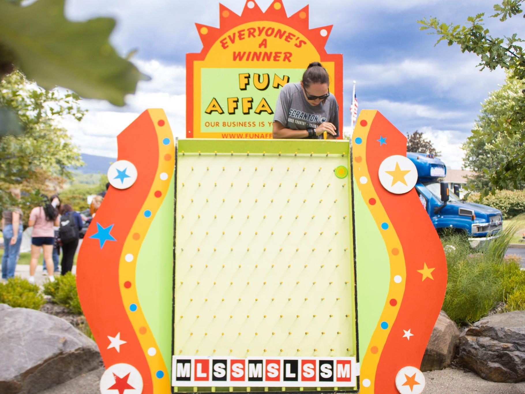 A student plays a Plinko-style game