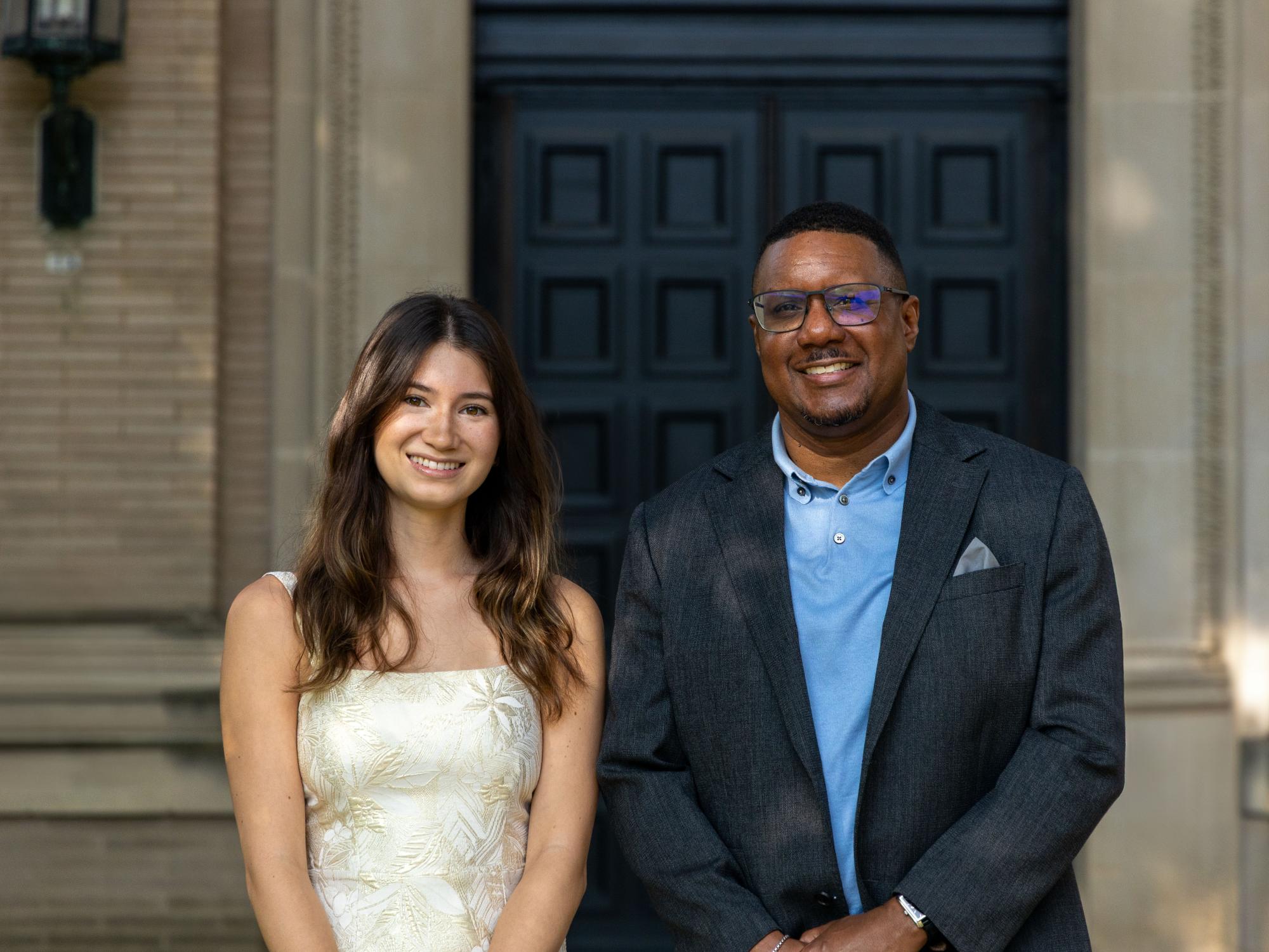 Emma Suzuki Szwajkowski (left) stands next to Clarence Lang (right), Susan Welch Dean of the College of the Liberal Arts, outside Sparks Building.