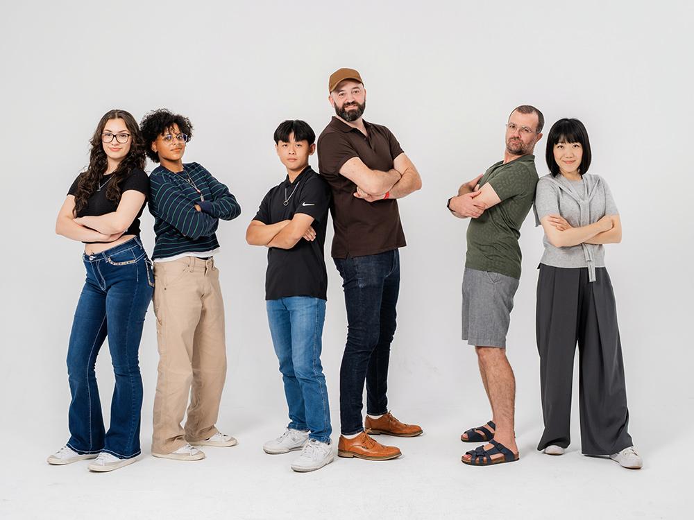 Amomii team standing on a white backdrop posing for a photo