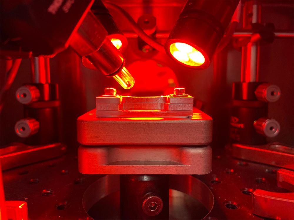 Picture of a piece of metal being welded in a laser welding system