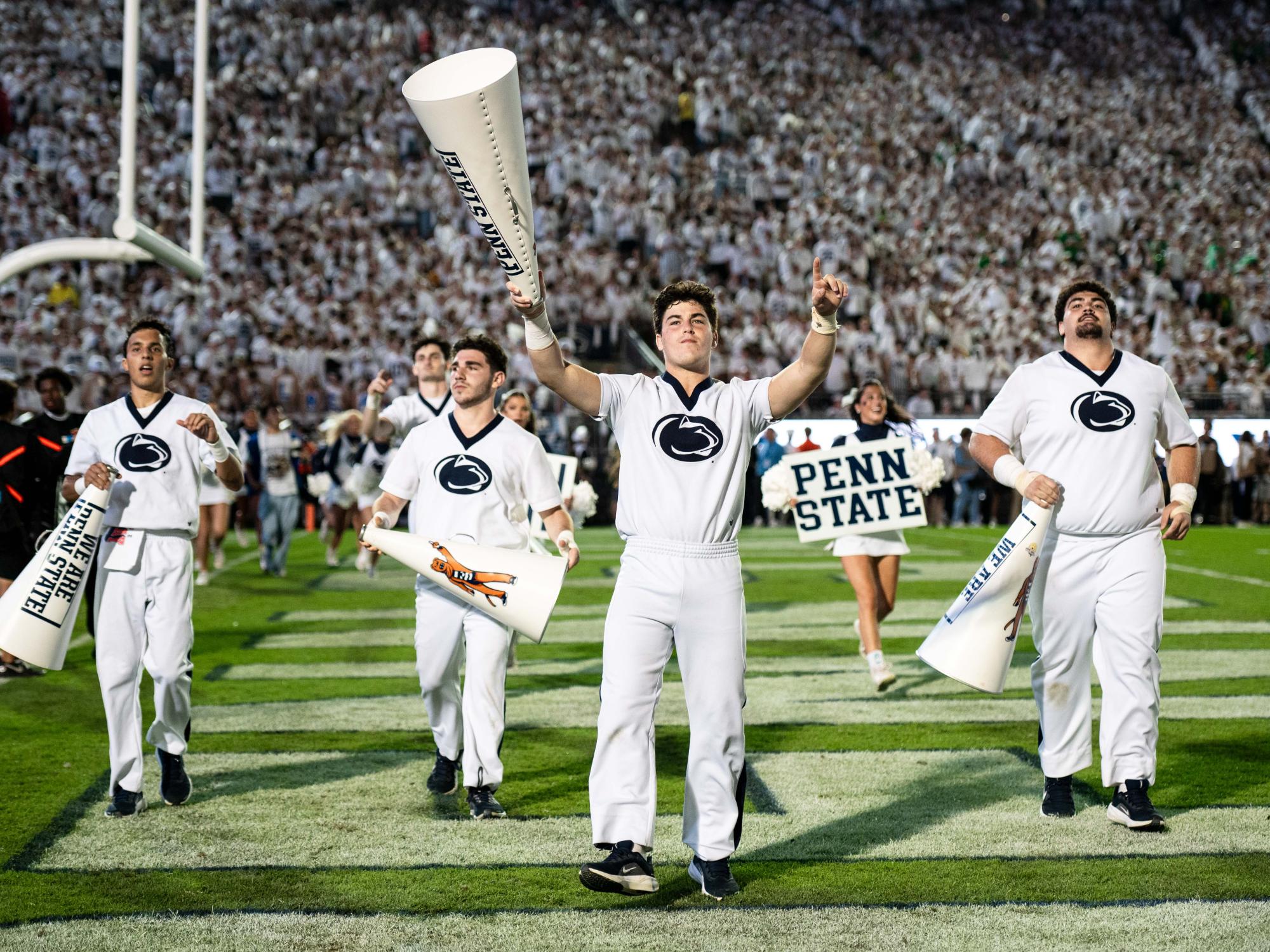 Cheer team cheering to the crowd in a football stadium
