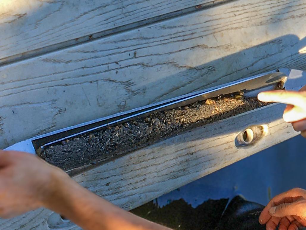 A tube of brown mud sitting on a wooden platform.