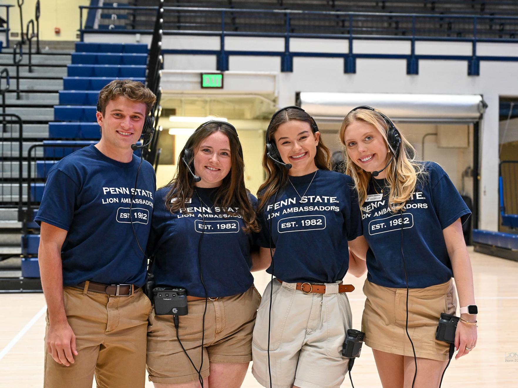 Ems wears a navy Lion Ambassadors shirt and gathers with other Lion Ambassadors while serving as co-chair of the Be A Part From the Start 2024 event.