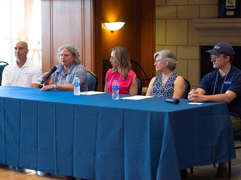 Group of five people sitting across a table