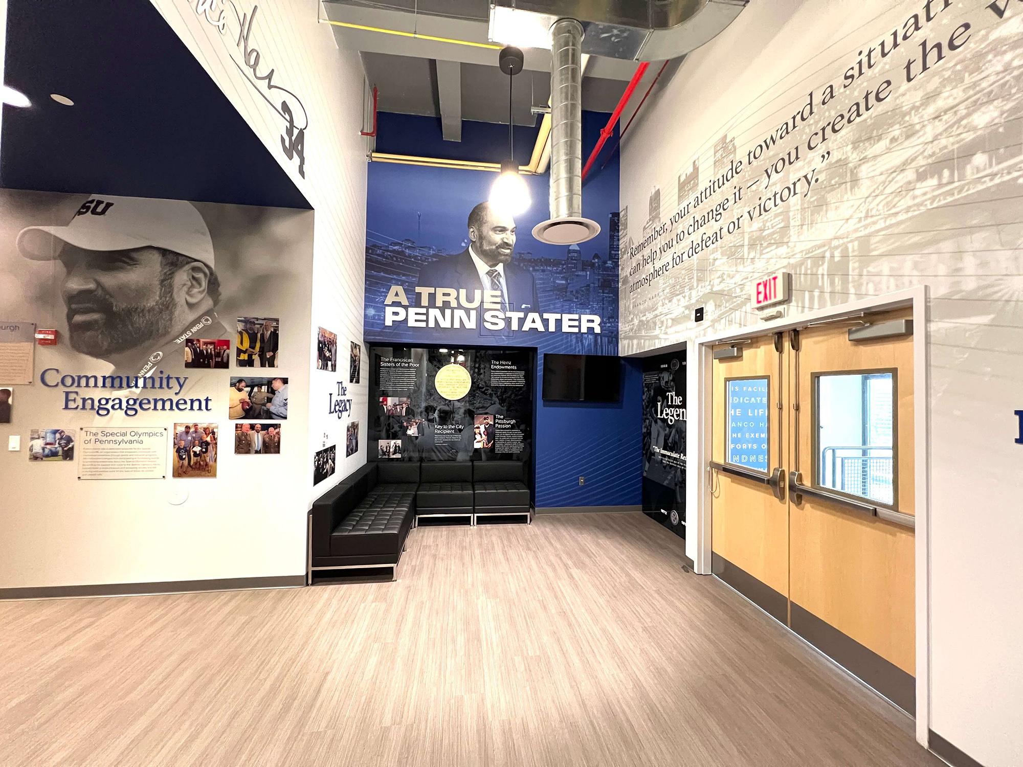 Franco Harris quotes, photos on display in a room with a wood floor.