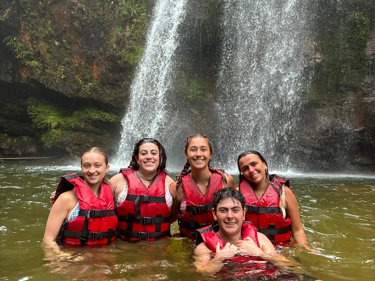 Students wear life preservers and swim near waterfalls in the mountains of Cuetzalan, Mexico. 
