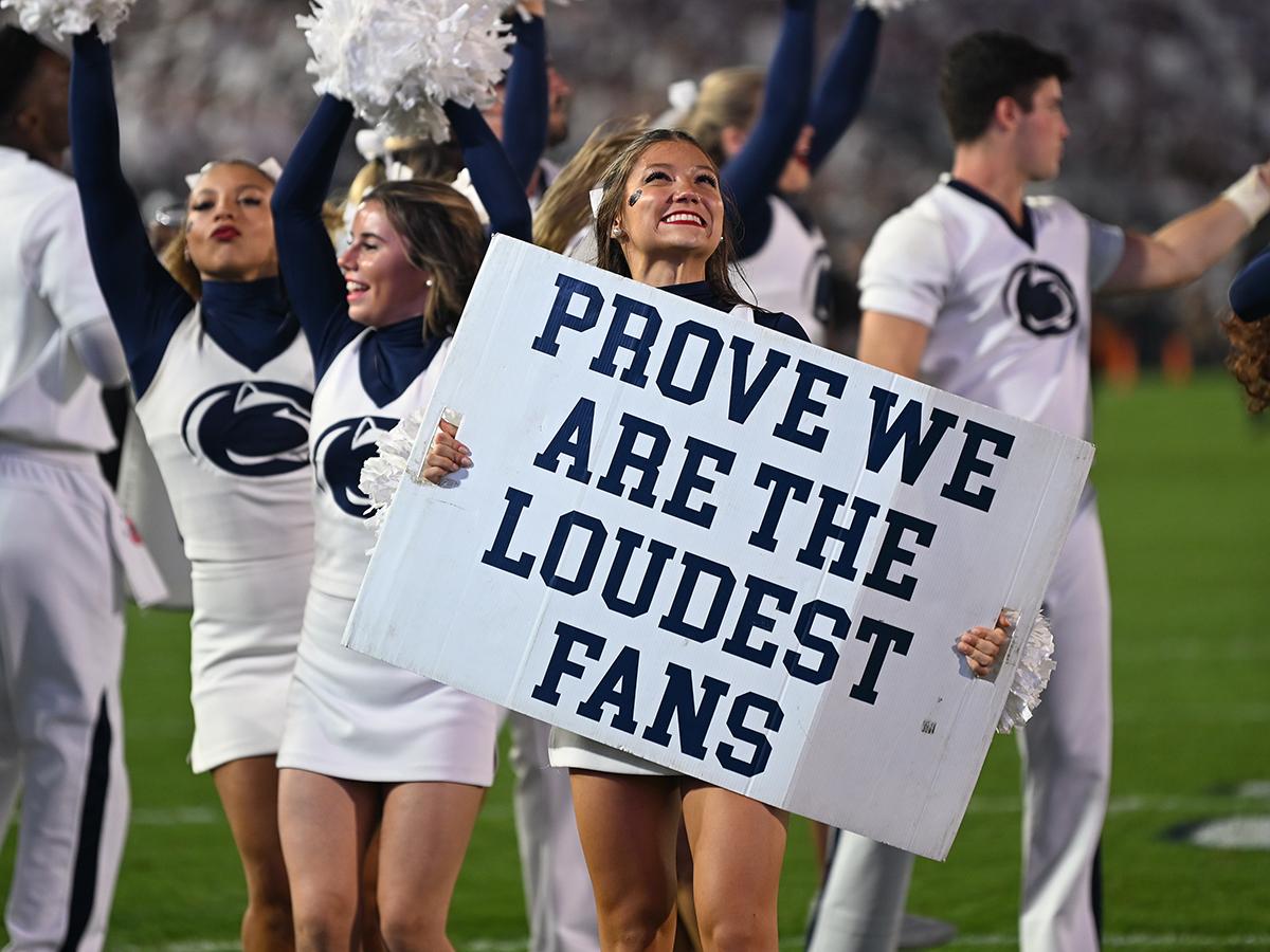 Female cheerleader holding sign