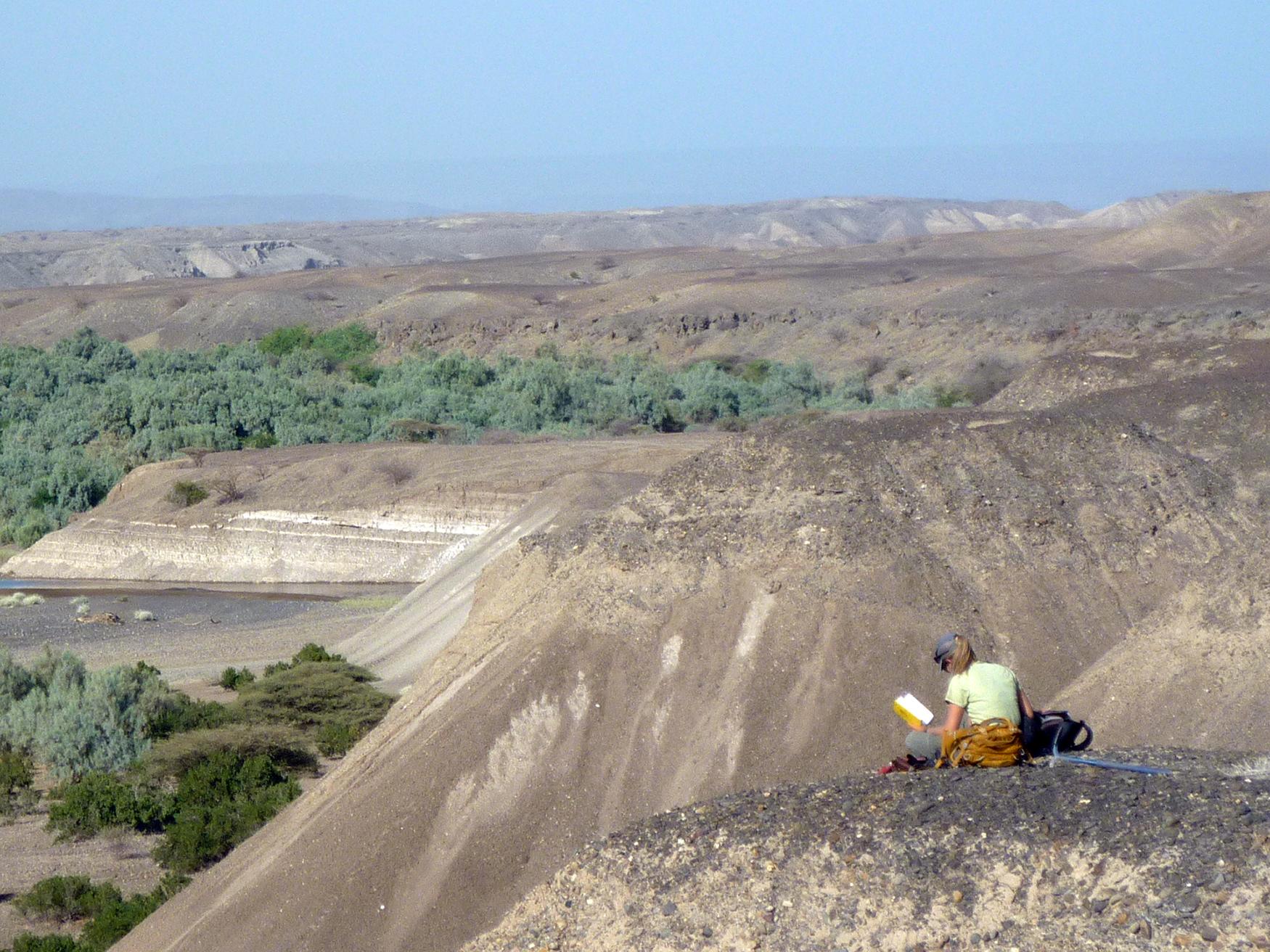 Erin DiMaggio takes notes along the Mille River in Ledi-Geraru in the Afar Region of northeastern Ethiopia.