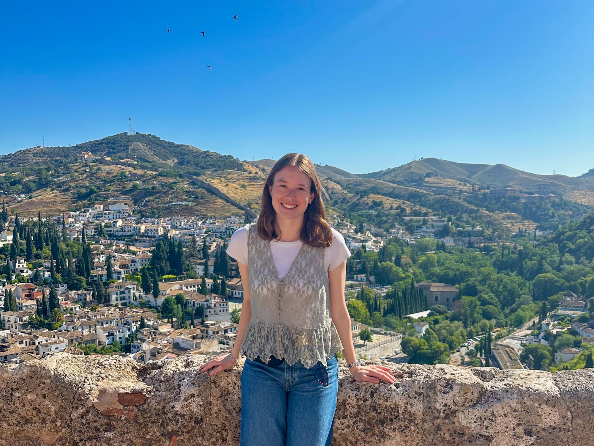 Avery Snowden stands near the Plaza de España in Ronda, Spain, with traditional Andalusian architecture in the background. 