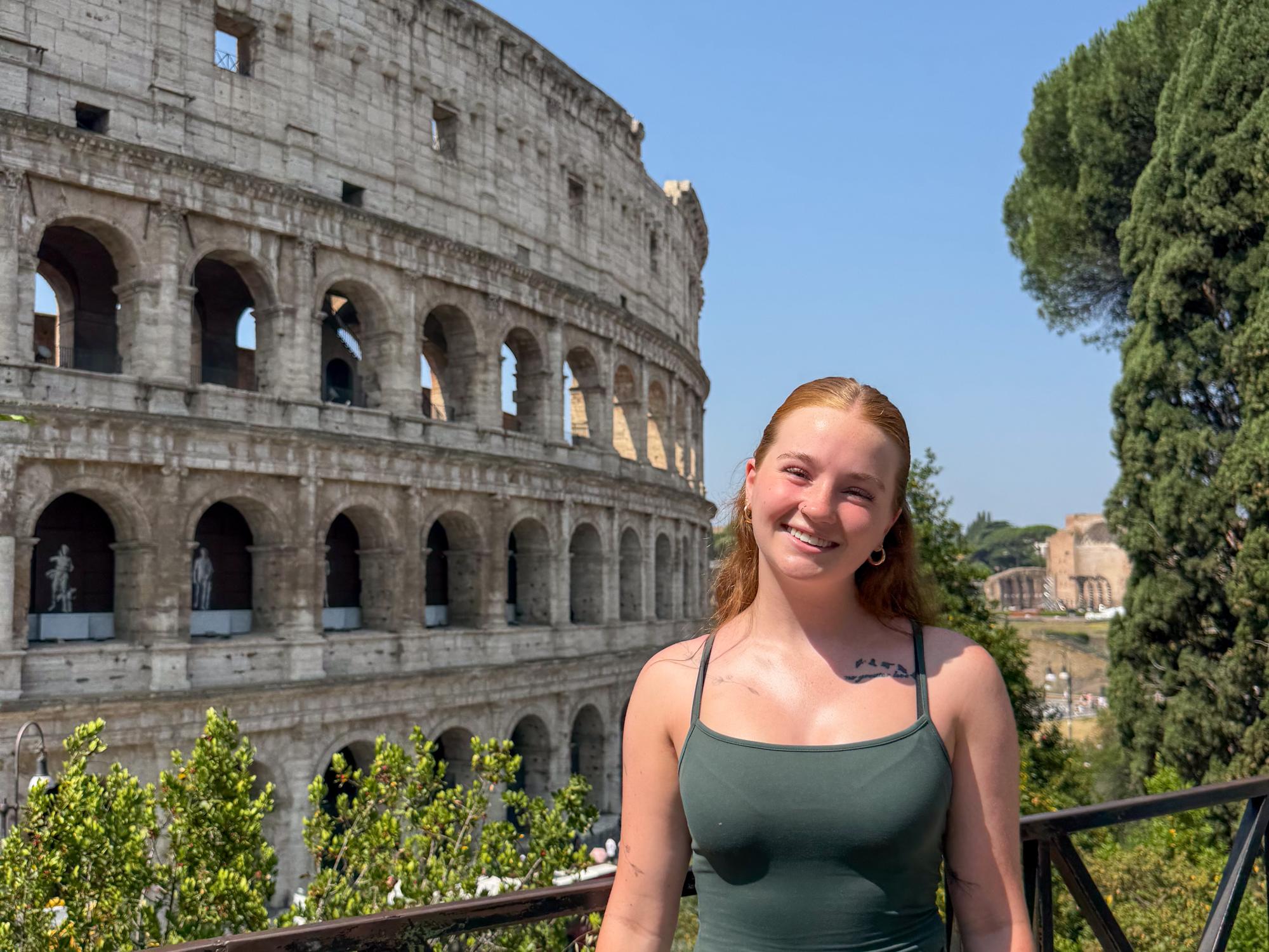 Student Ryan Murphy stands in front of the Colosseum during a class tour of Rome.
