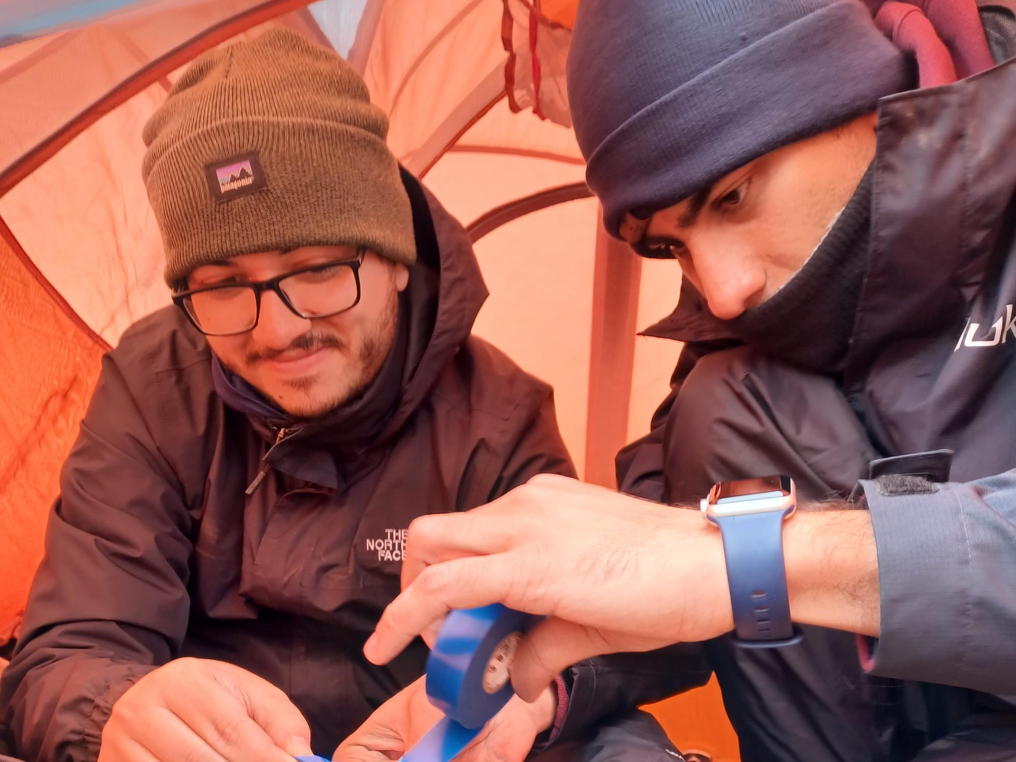 Gabriel Rocha Dos Santos, a doctoral candidate at Penn State, and Ahmad Tourei of the Colorado School of Mines fix a cable near the Arctic Ocean on Aug. 9, 2022.