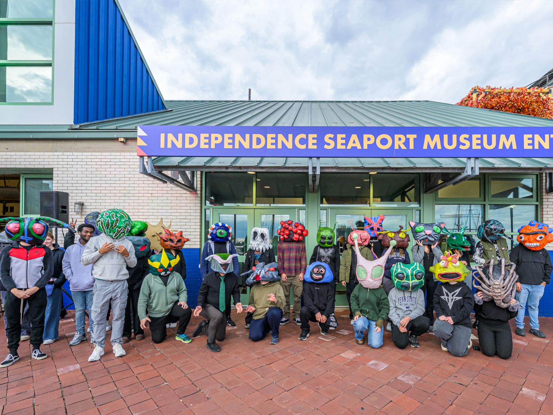 people wearing alien masks