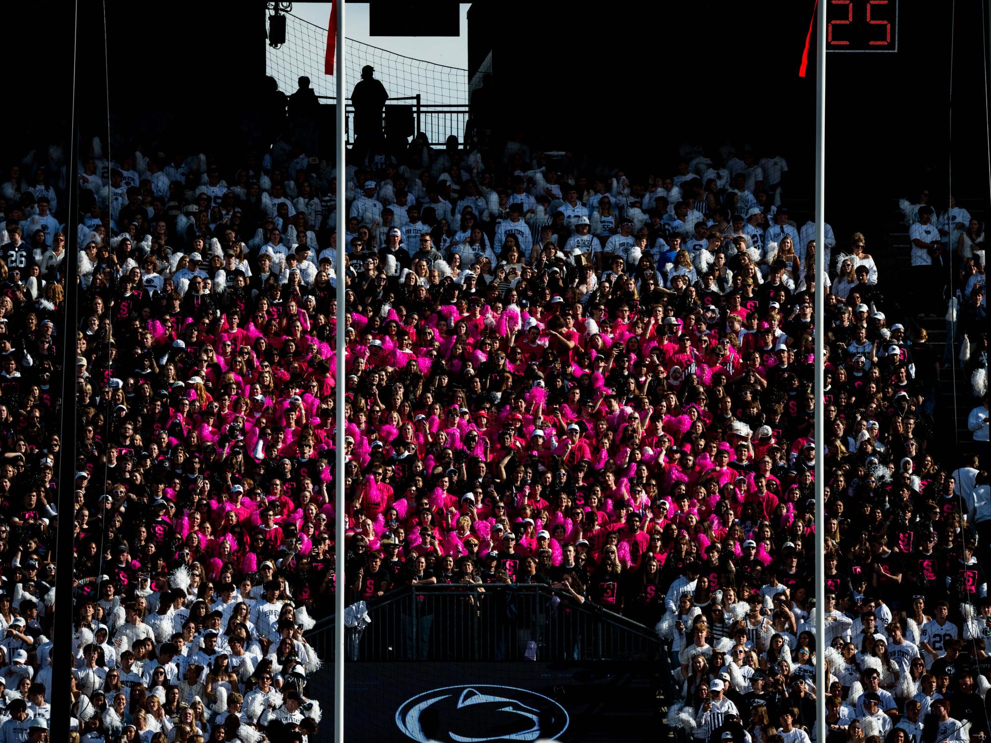 A section of Penn State football fans dressed in bright pink to form a S