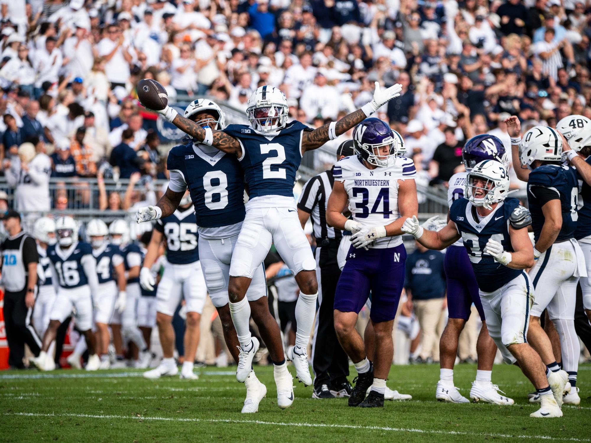 A football player jumping with football in hand