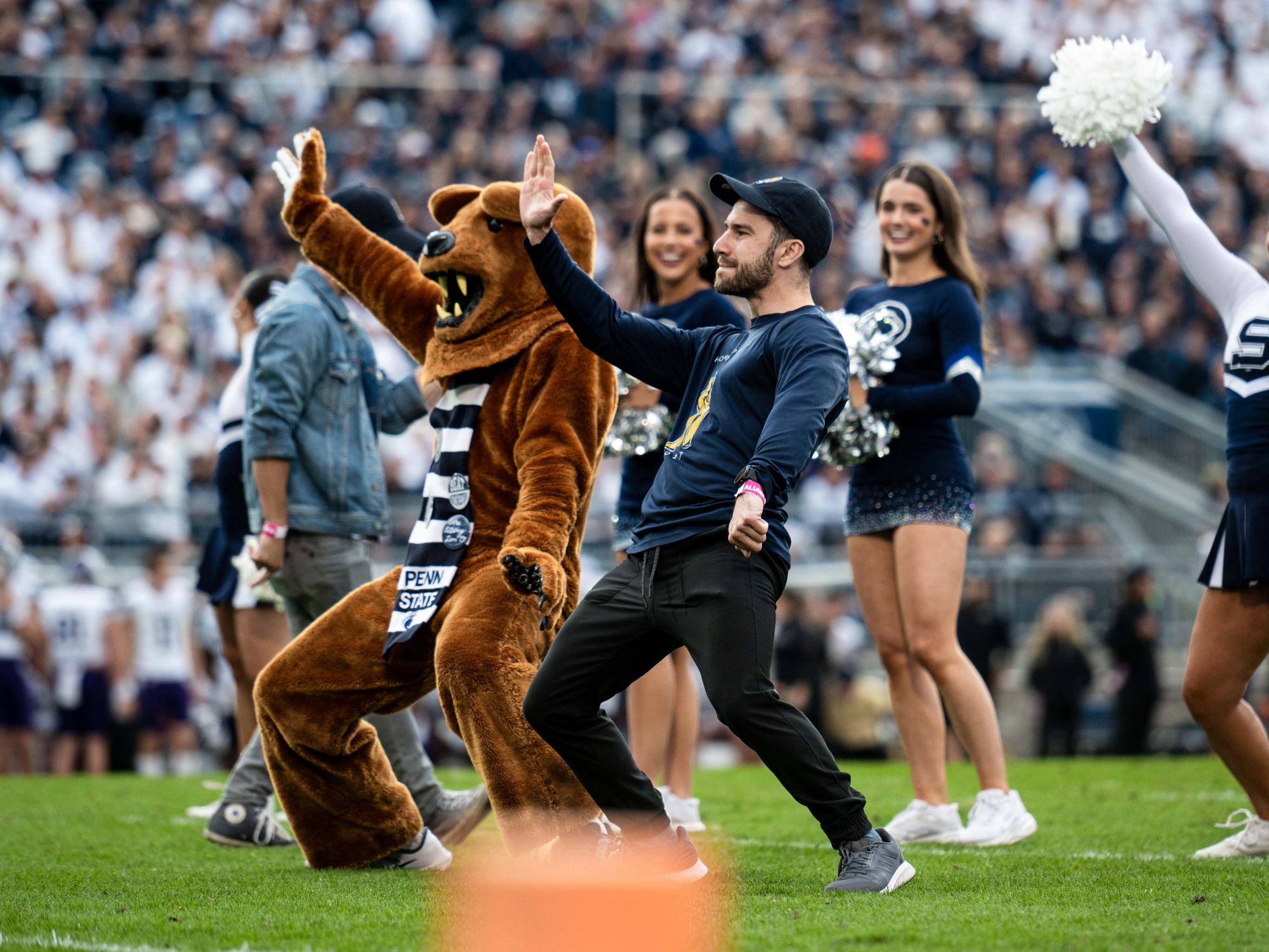 Penn State Nittany Lion mascot and a person dancing beside each other.