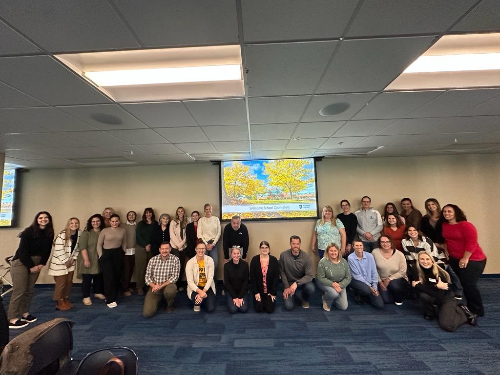 School counselors at Penn State Lehigh Valley standing in front of a screen.