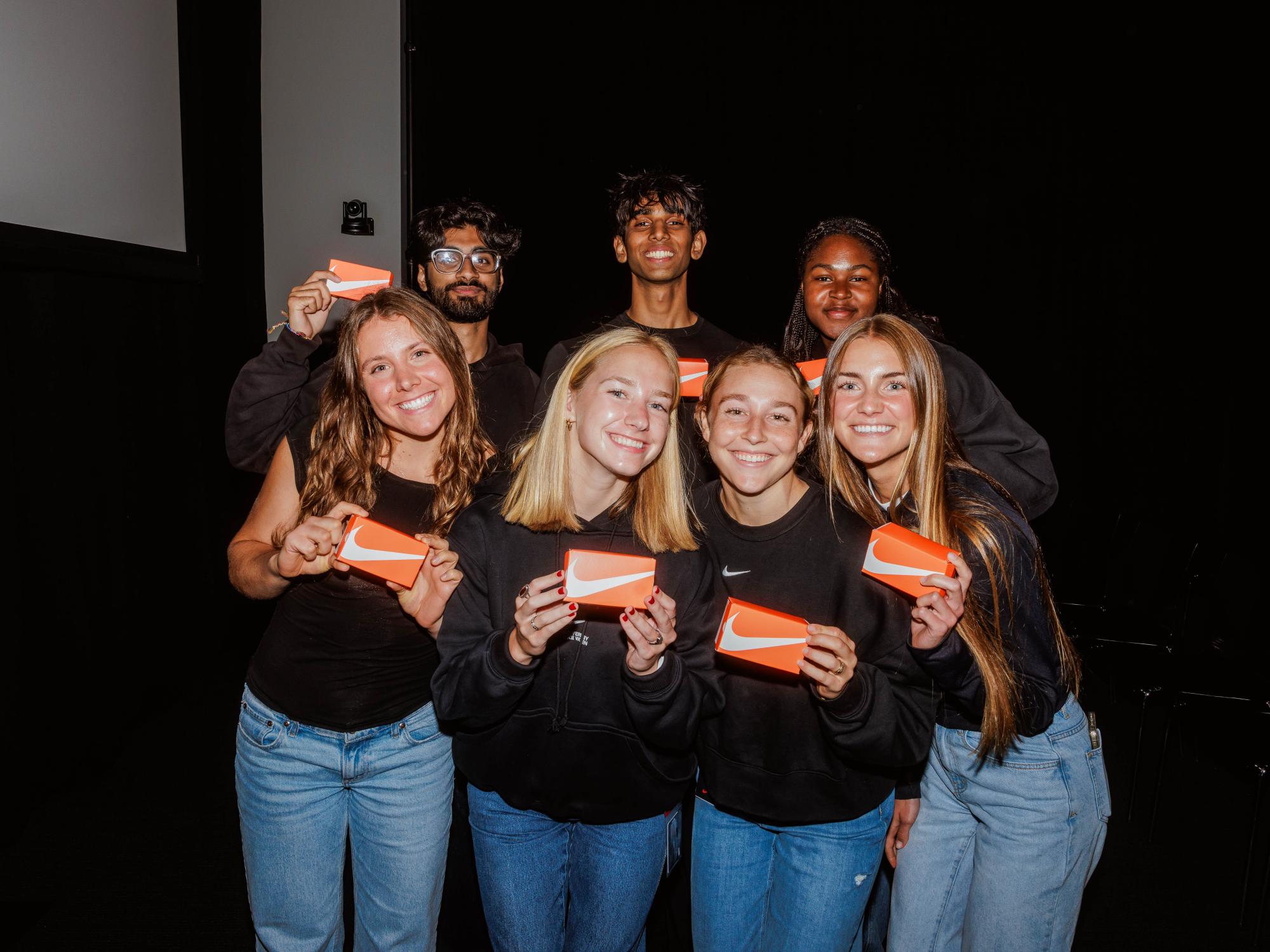 Katie Dallas (first row, second from left) gathers with her Combine competition group at Nike World Headquarters, with the group all wearing black shirts and jeans.