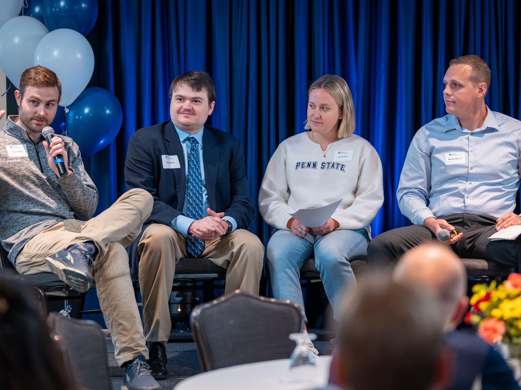 four person panel at conference