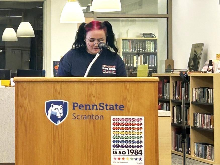 female student reads at podium