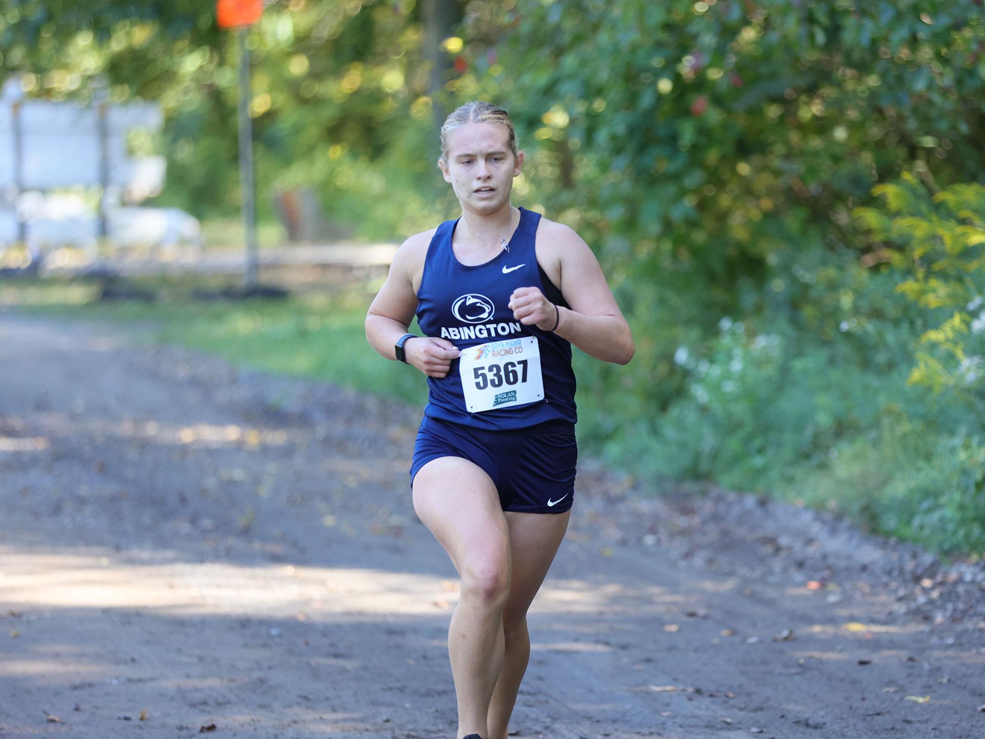 Woman running in a college uniform