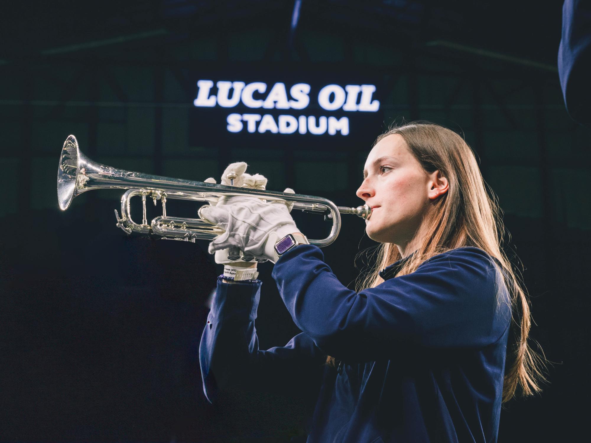 Lucy Schilling plays the trumpet in her Blue Band uniform at Lucas Oil Stadium.