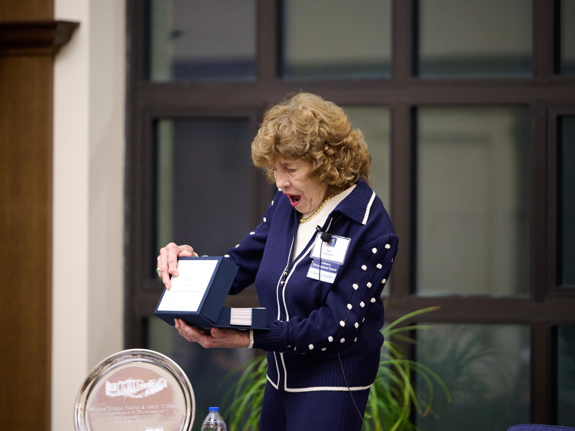 surprised woman opens box in her hands