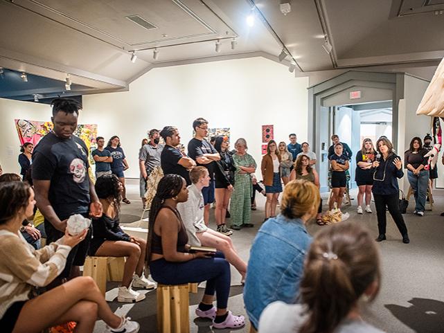 A large group of people in an art gallery