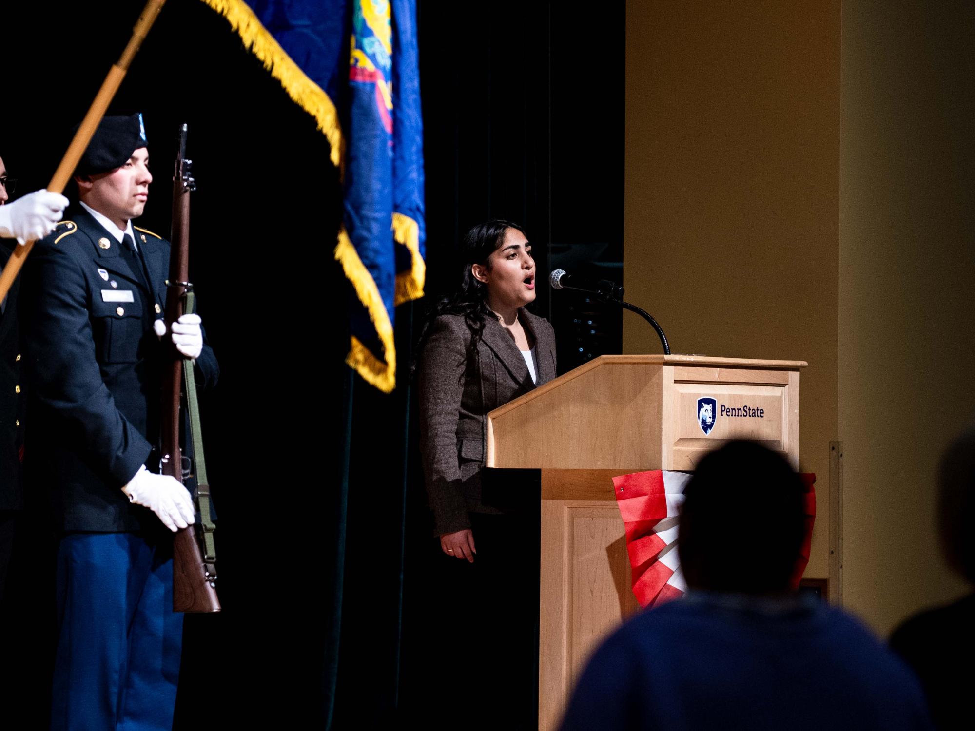 A person singers at podium on stage