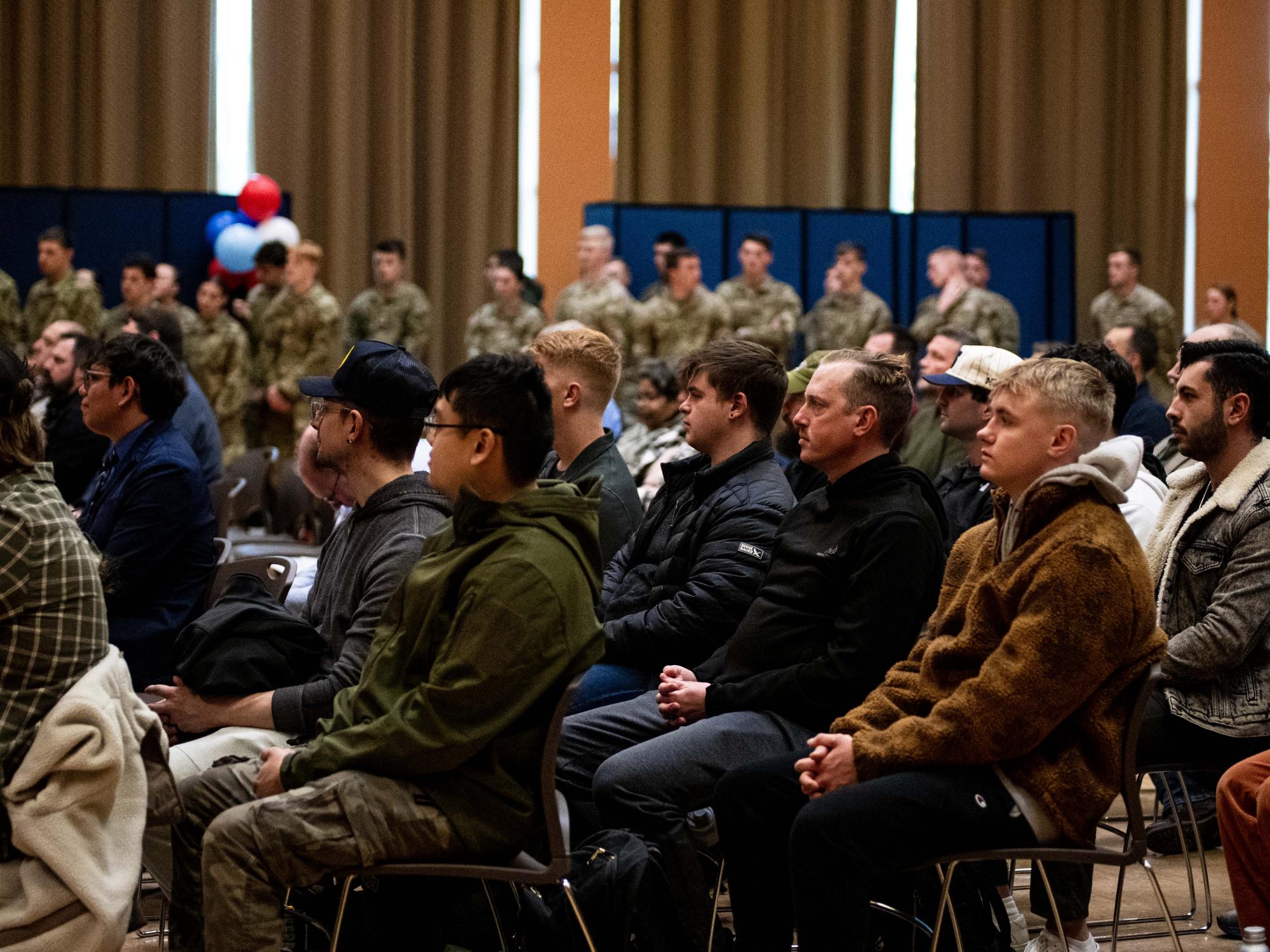 People in a crowd sitting on chairs