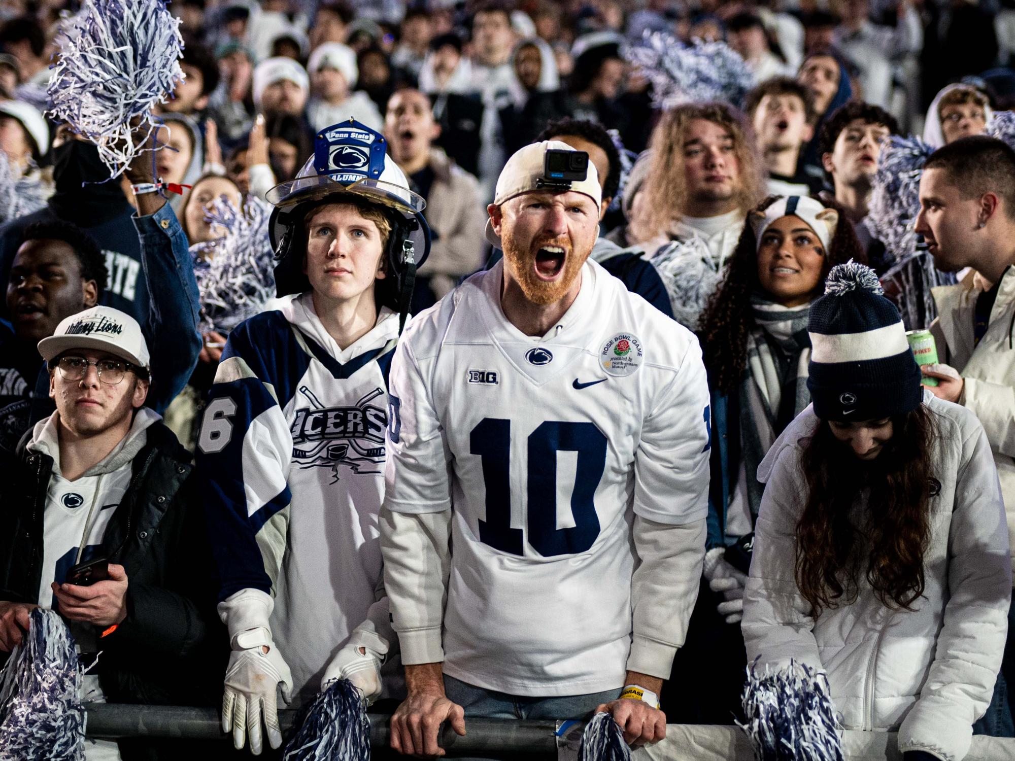A student in a football crowd yelling 