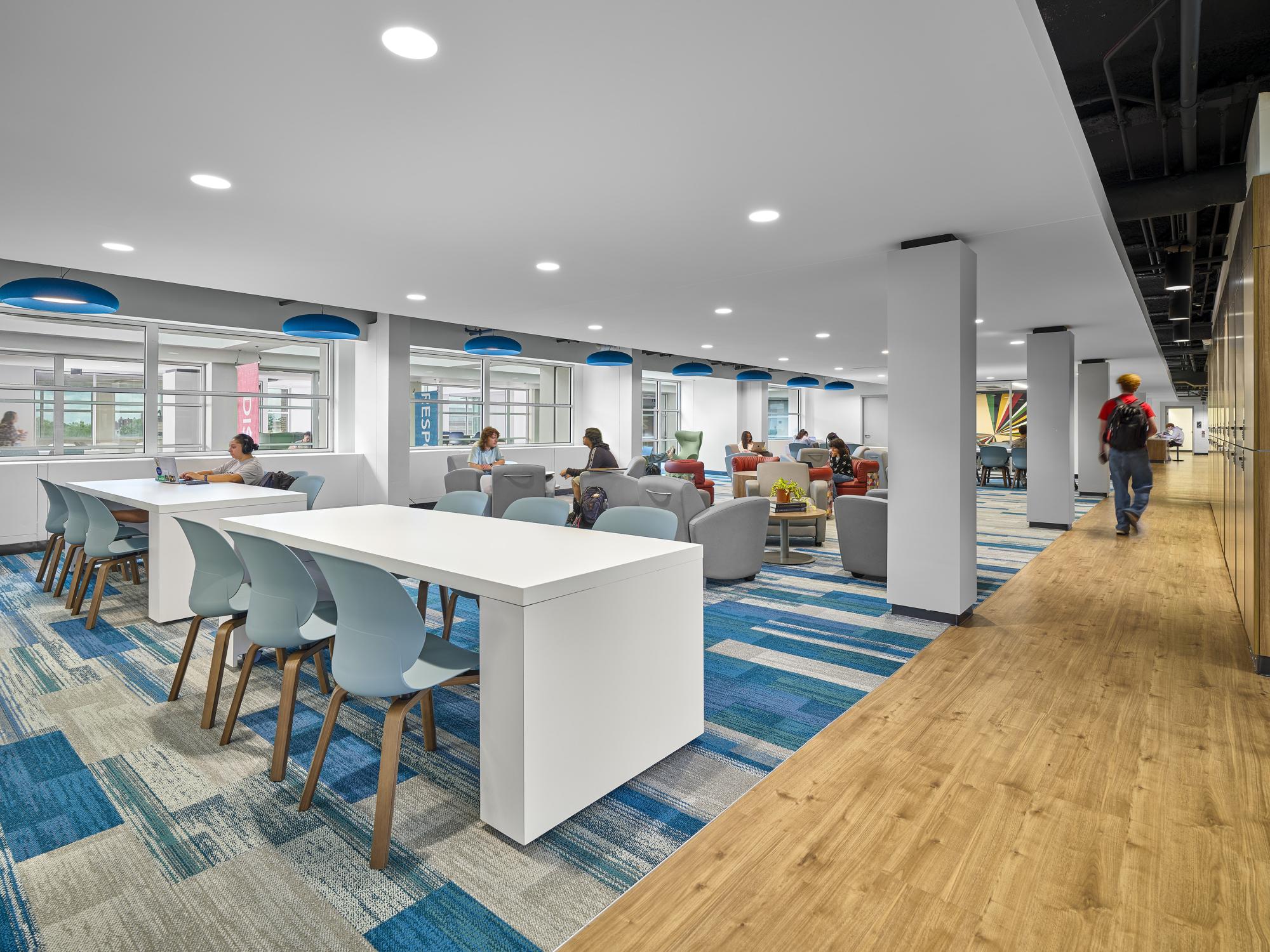 Showcasing a different angle of the very large lounge and study space in the center of the floor with the Black Caucus office space shown in the center back.