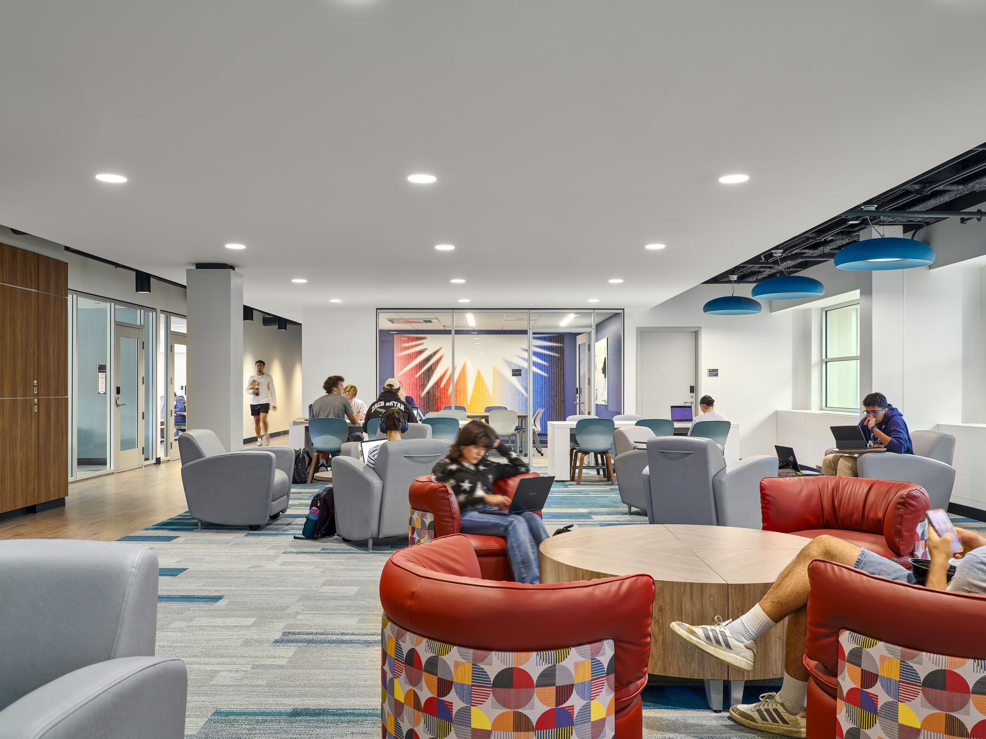 Large lounge and study space in the middle of the floor showcasing the Latino Caucus office in the background and the student government offices on the left.