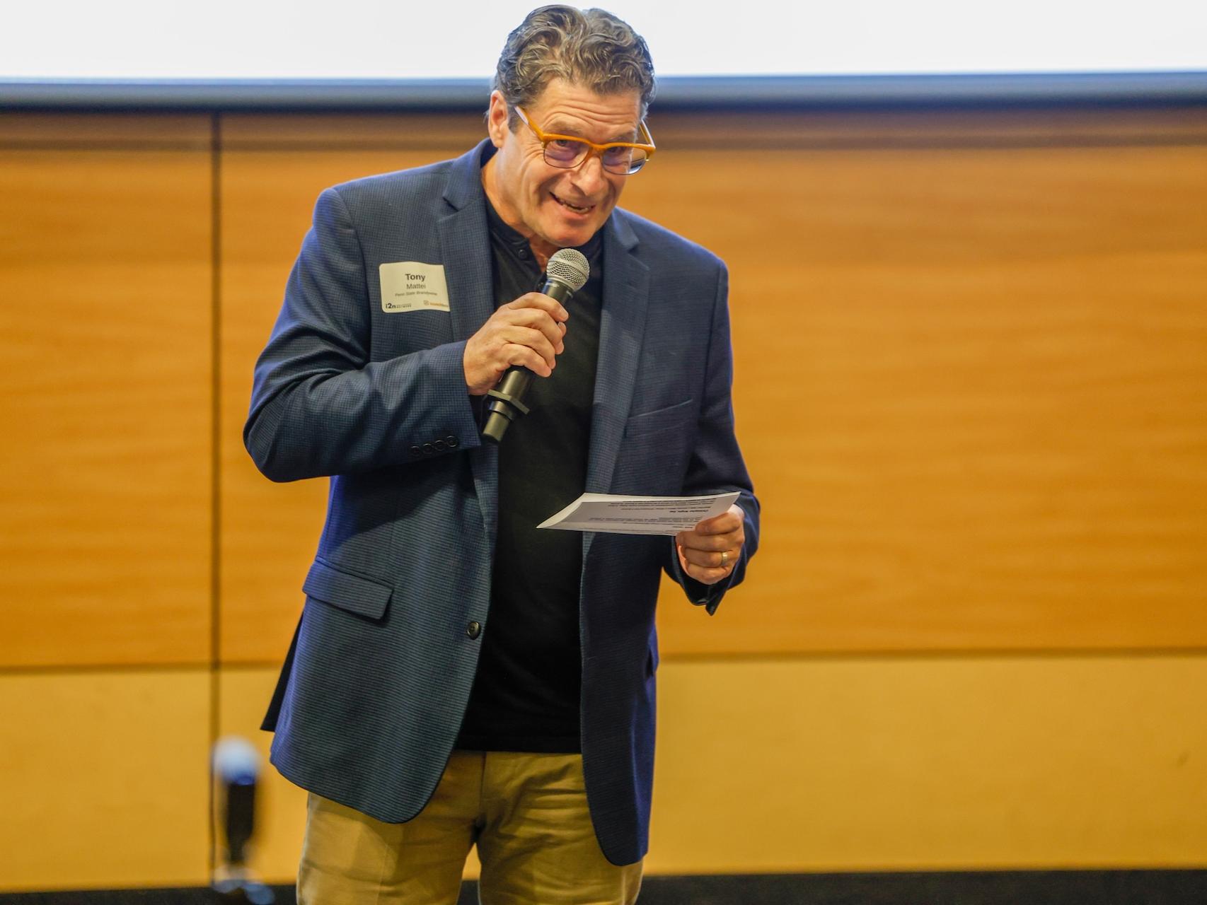 tony mattei speaking on stage
