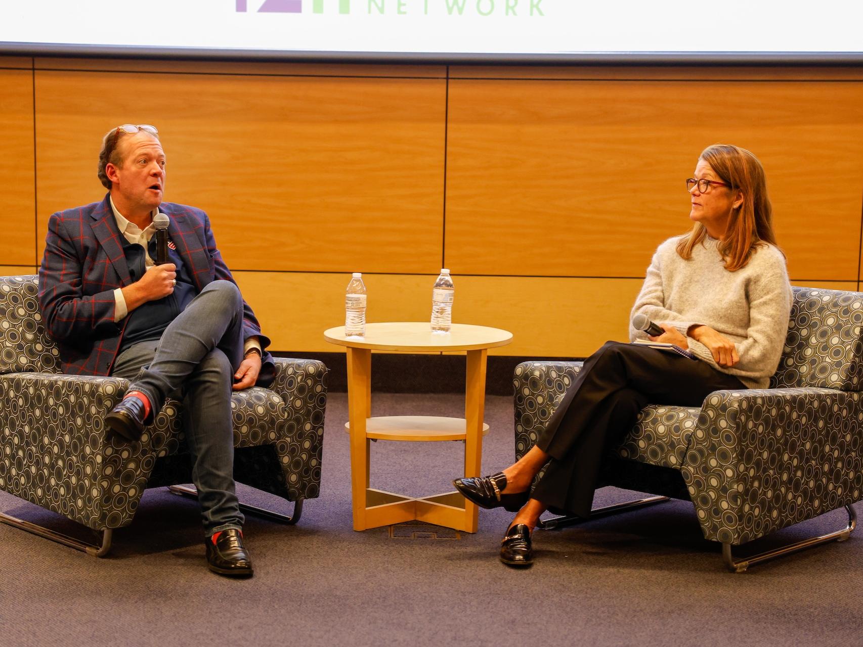 Jen Gilburg and Michael Carter giving fireside chat on stage 