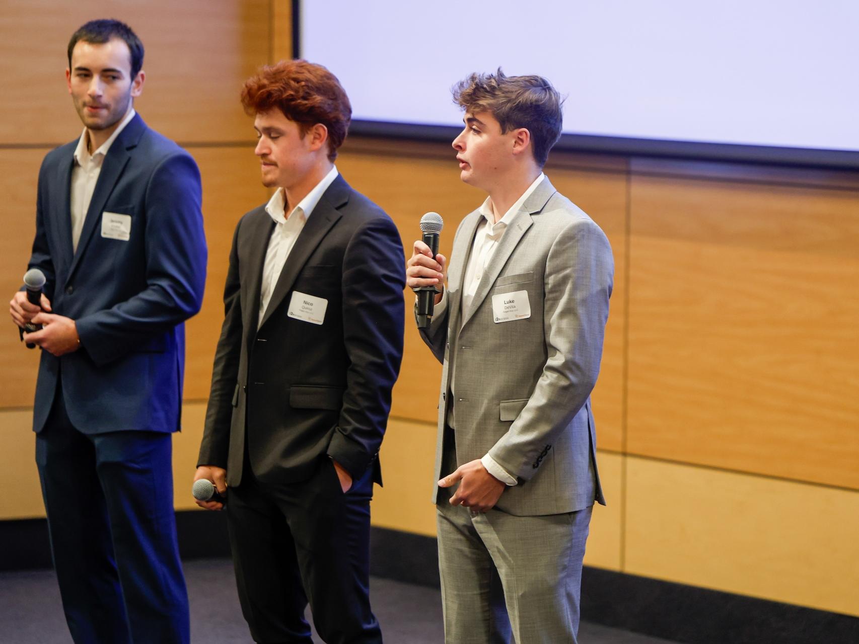Luke DeVita and his team speaking on stage