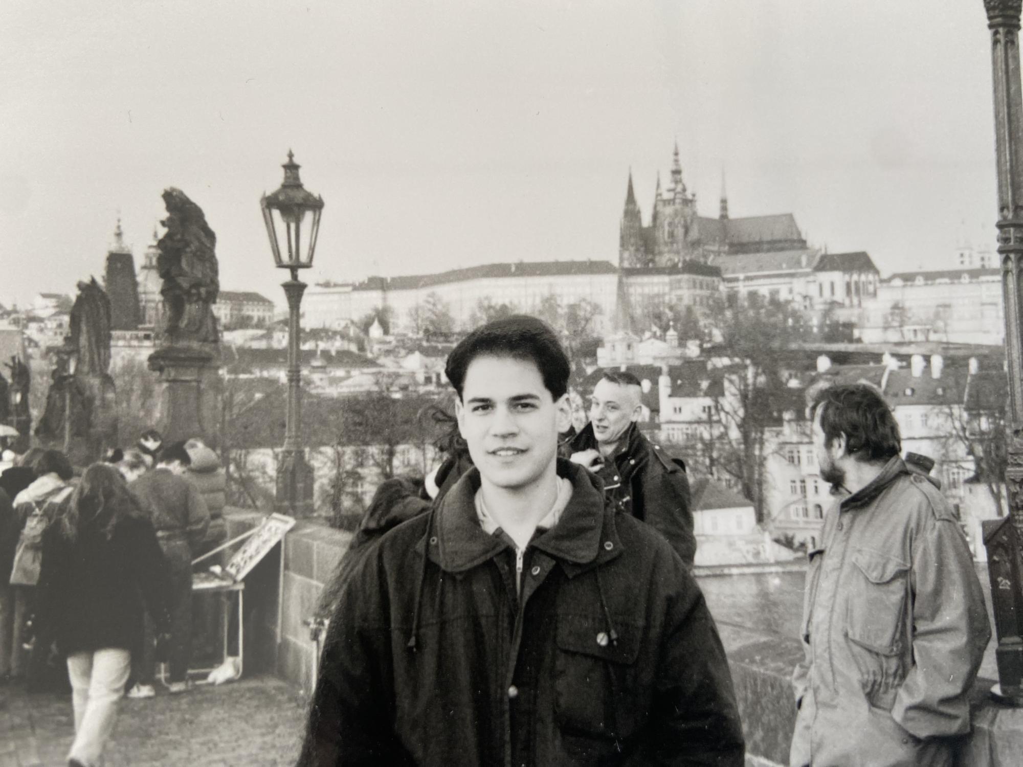 A black-and-white photo of a young Ben DeAngelo with a view of Prague Castle.