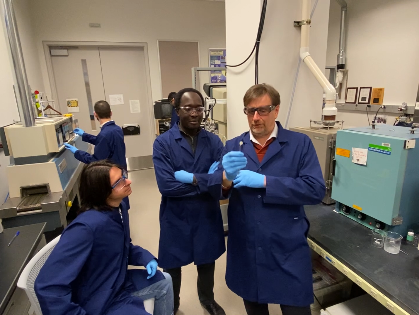 Three men working in a lab