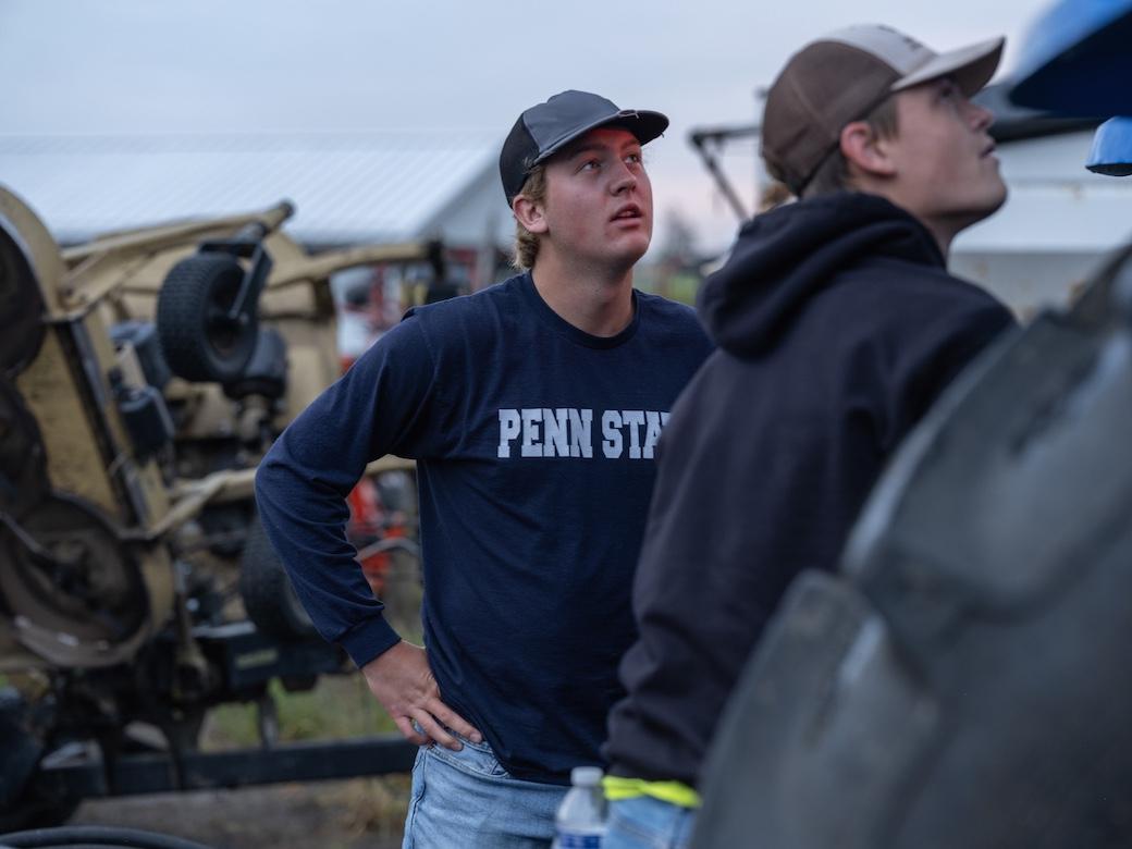 Two ag students examine a tractor.