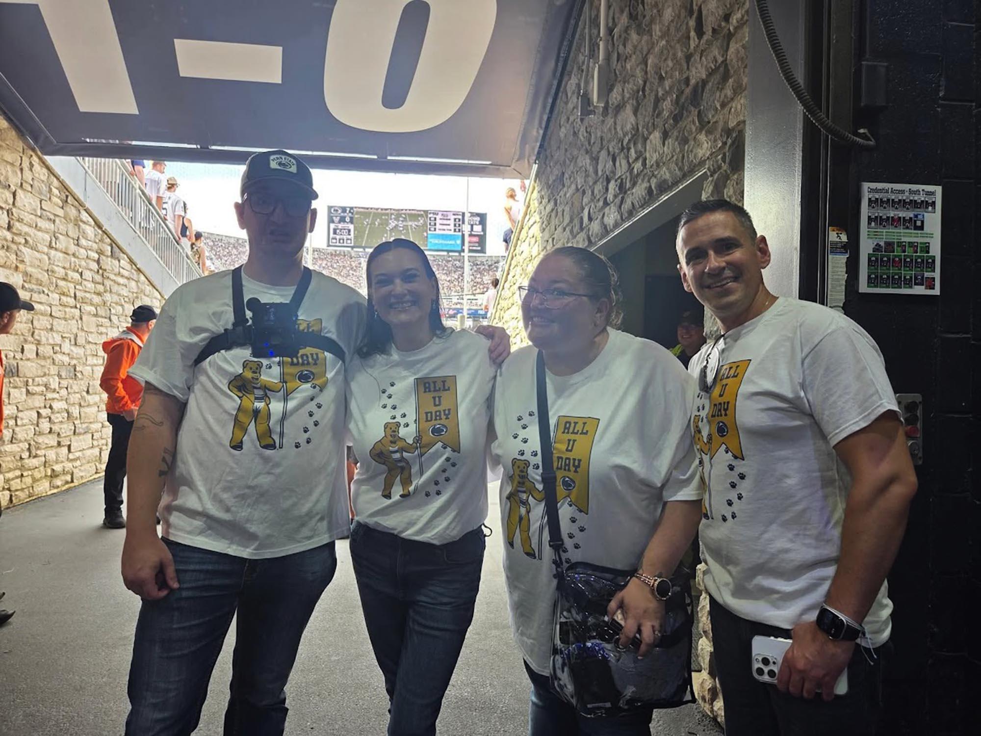 four people stand in the tunnel of Beaver Stadium