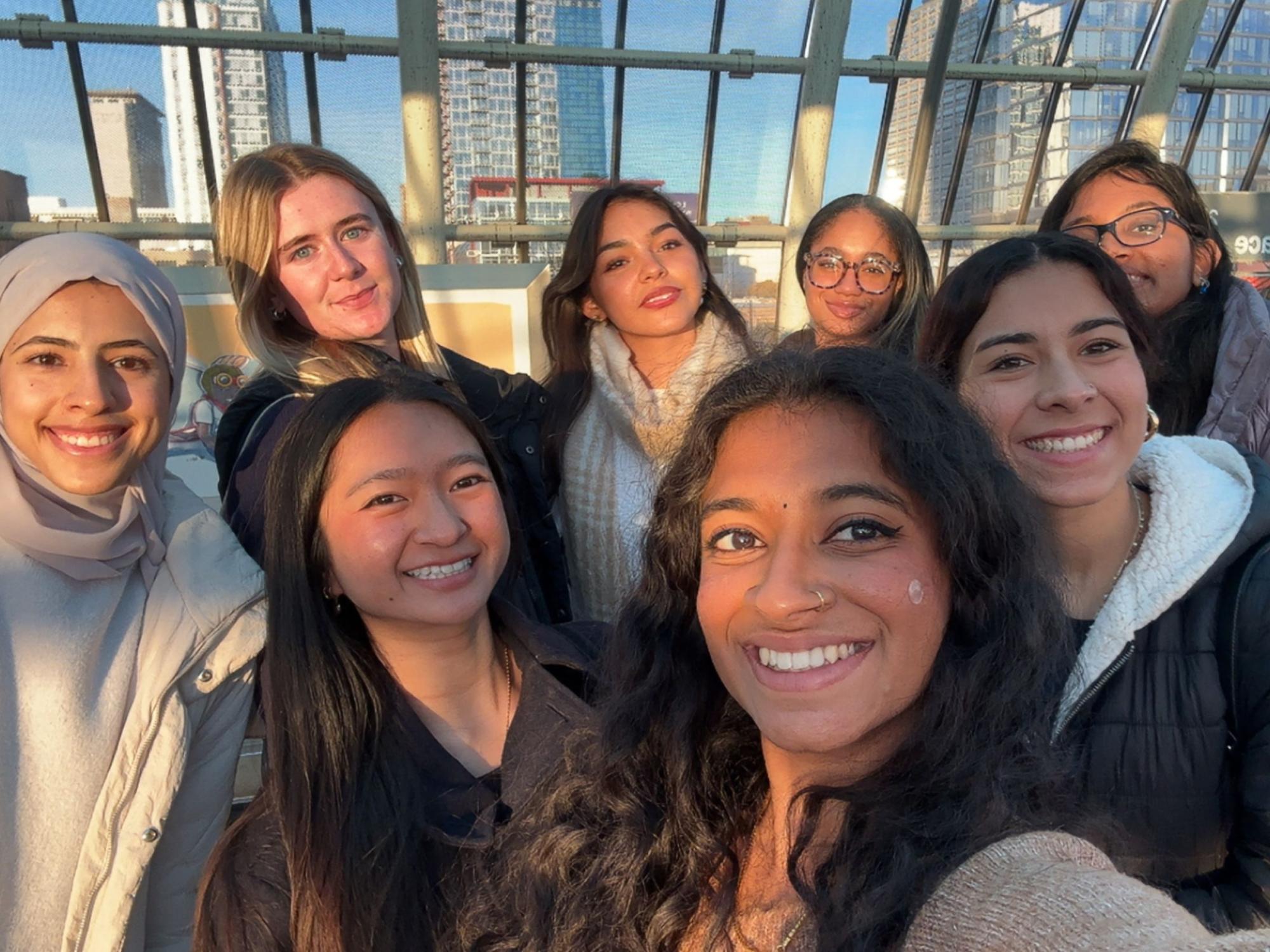 college students in group selfie with Chicago in the background